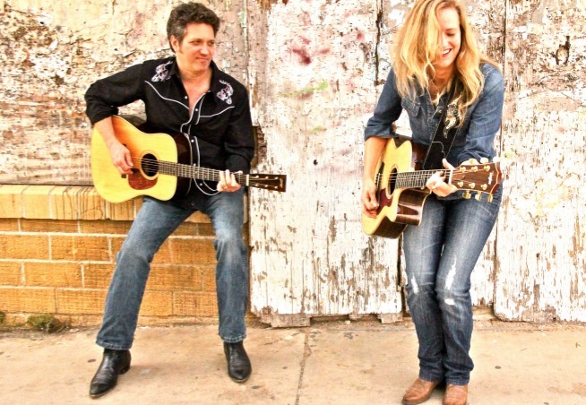 Stuart Adamson and Hilary Claire Adamson, The Flyin' A's, pictured with acoustic guitars.