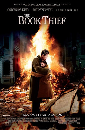 Main character Leisl hugs her adopted father in front of a bonfire which is burning books