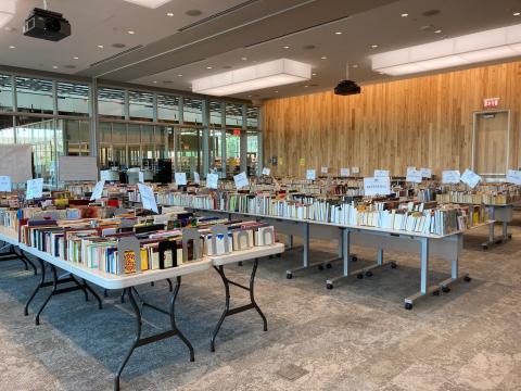 Books are displayed on tables for the book sale