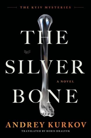This simple cover features a shiny silver bone against a black background.