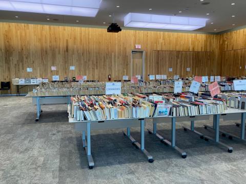 Tables of books are displayed for the Friends of the Library book sale.