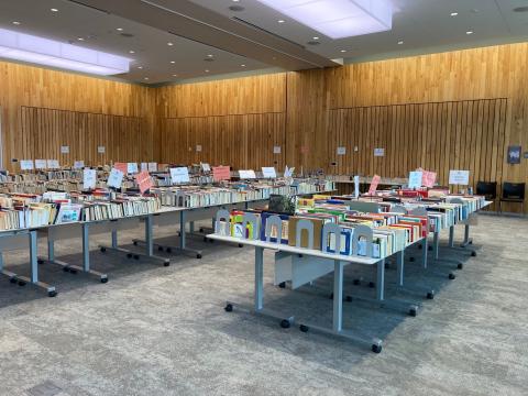 Tables of books are displayed for the Friends of the Library book sale.