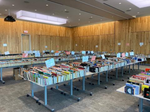 Books are displayed on tables for the book sale