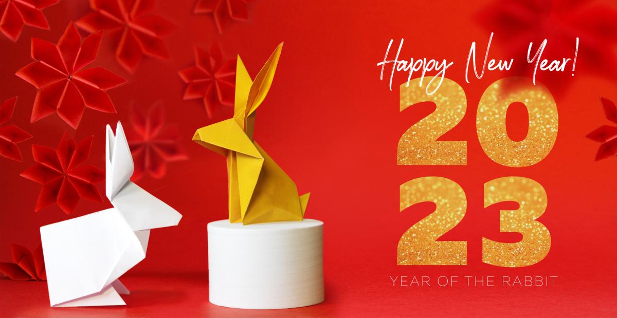 Origami rabbits and text that says Happy New Year 2023.